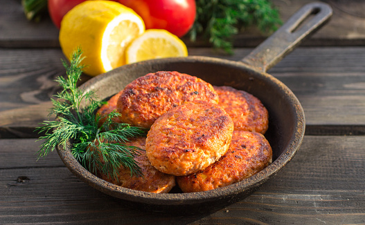 A skillet holding several low carb fish cakes.