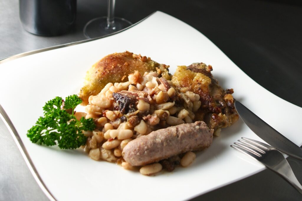 A plate of French cassoulet with sausage and beans.