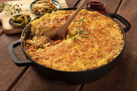 A skillet of shepherd's pie with a golden brown potato topping.