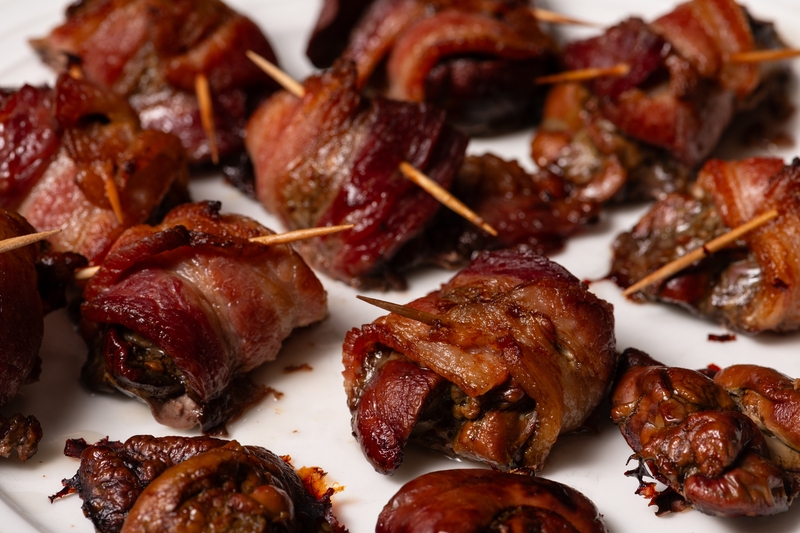 Bacon wrapped chicken liver appetizers secured with toothpicks.