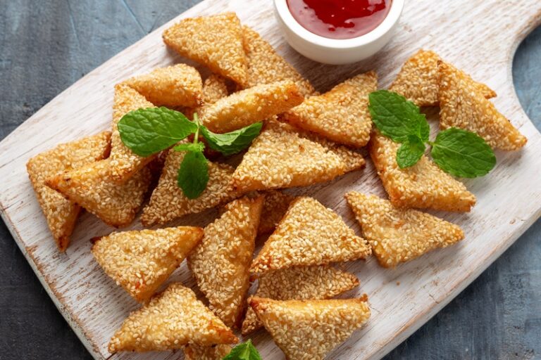 A plate of Chinese prawn toast with herb garnish.