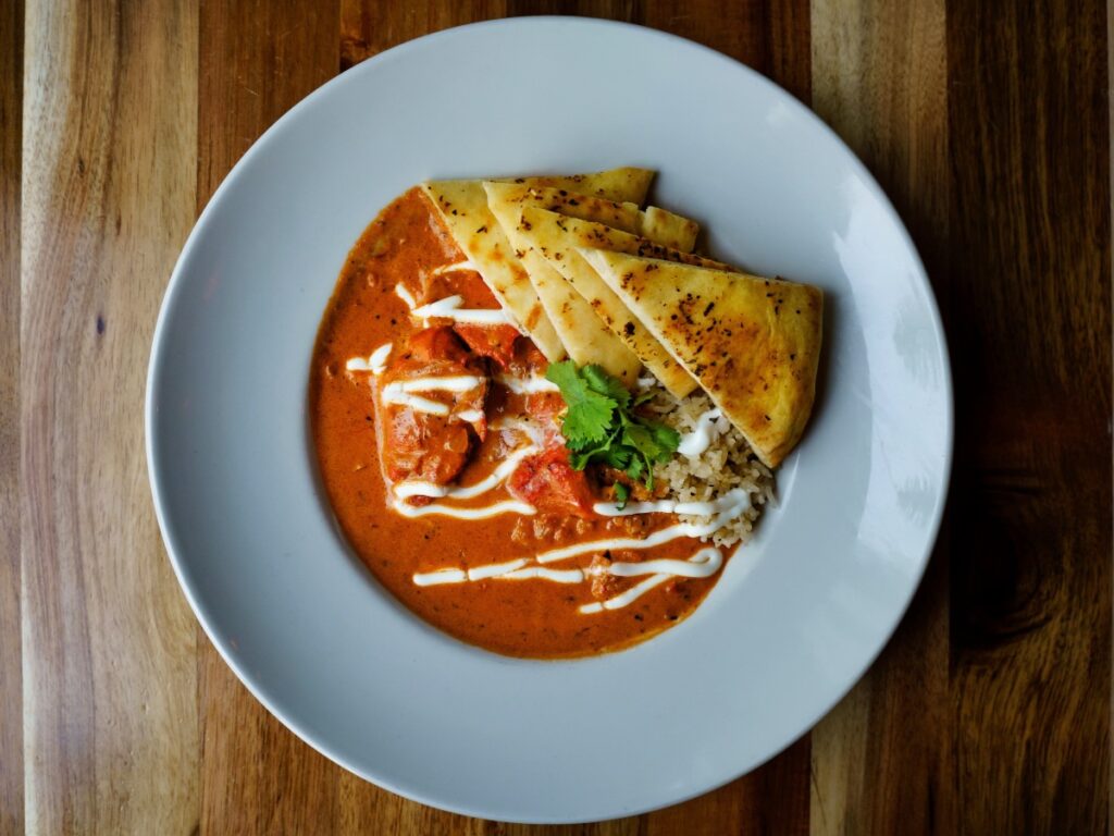 A bowl of butter chicken, a British Indian food dish.