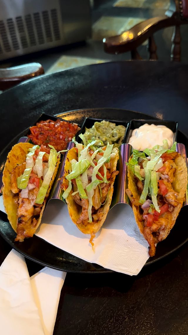 Chicken thigh tacos with toppings.