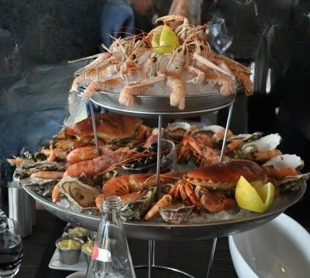 Two-tier seafood platter with langoustines, prawns, crab and oysters
