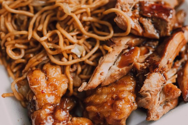 Sticky sweet chicken thighs with noodles.