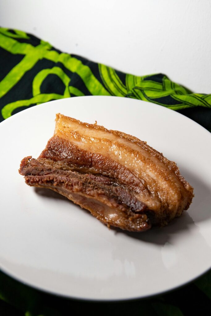 A slice of crispy speklappen on a white plate.