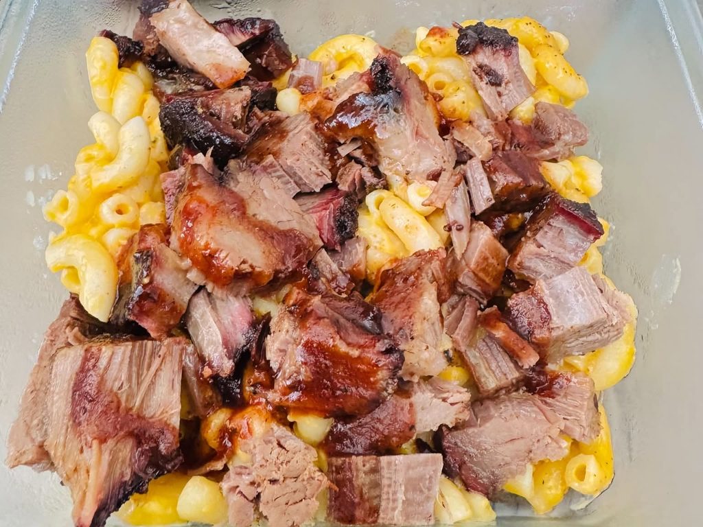 Homemade smoked brisket mac and cheese in a plastic container.