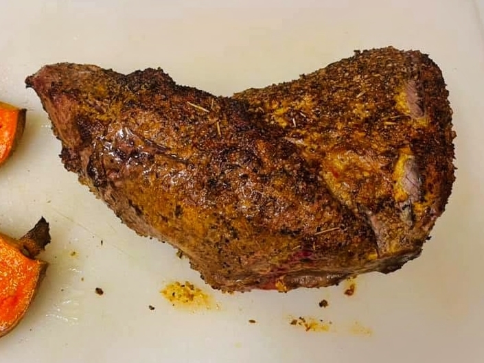 Smoked tri-tip on a cutting board.
