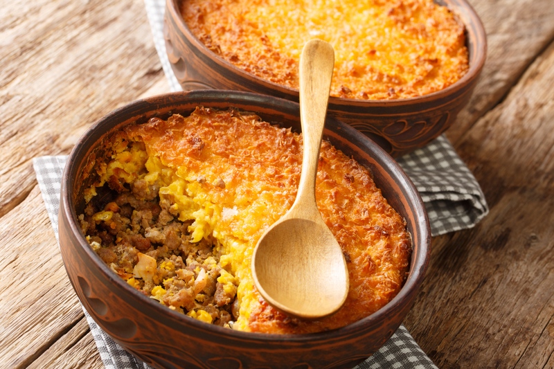 Two baking dishes of pastel de choclo.