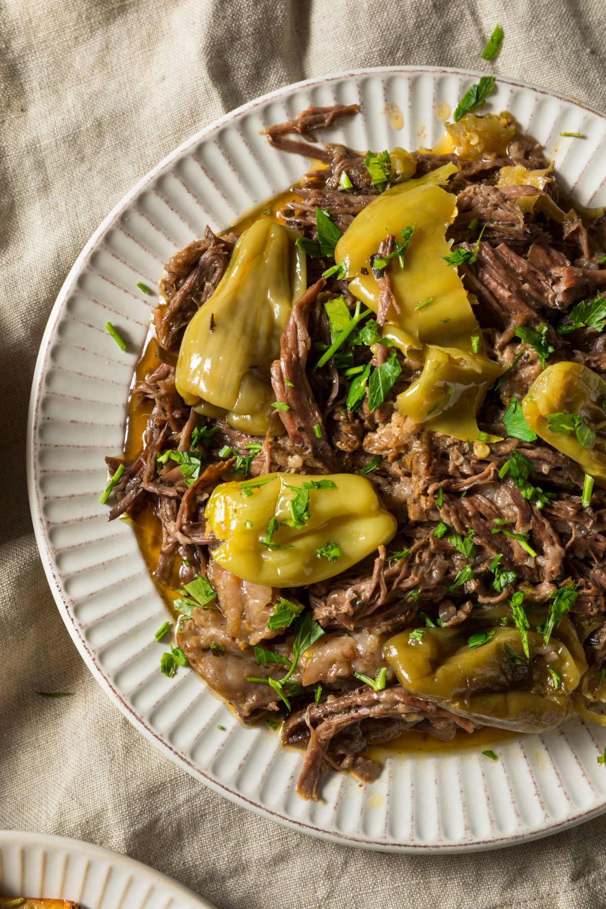 A dish of Mississippi pot roast with beef and pepperoncini.