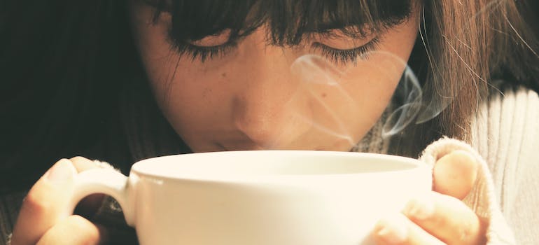 a close-up of a woman drinking coffee