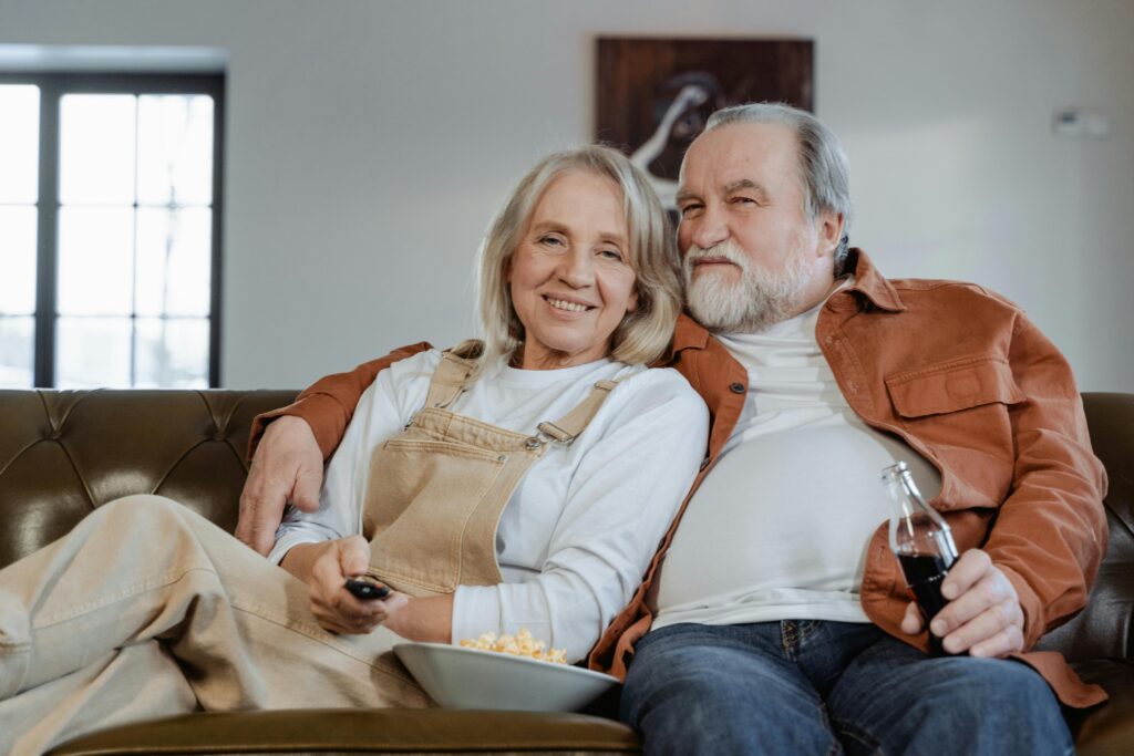 Older couple relaxing on a couch.