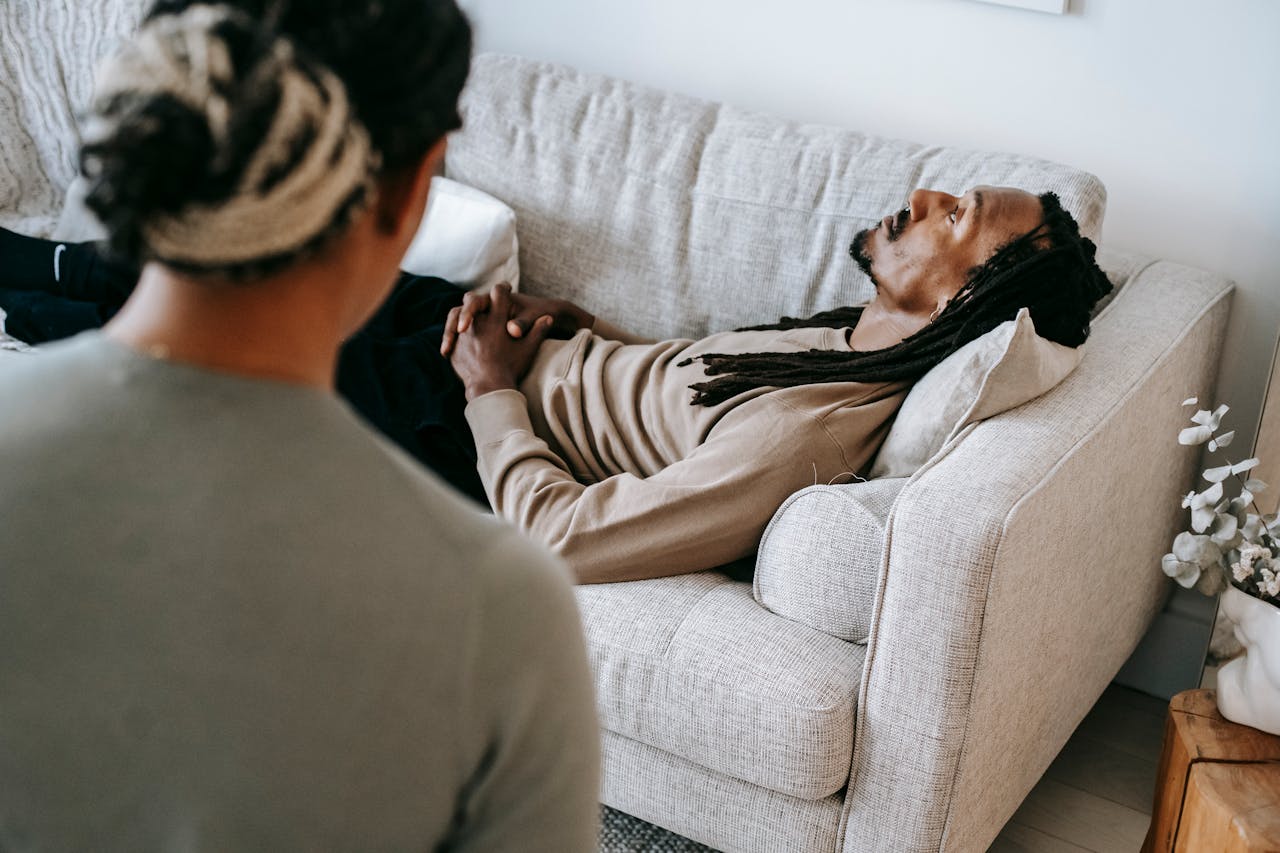 a black man lying on a couch having psychotherapy