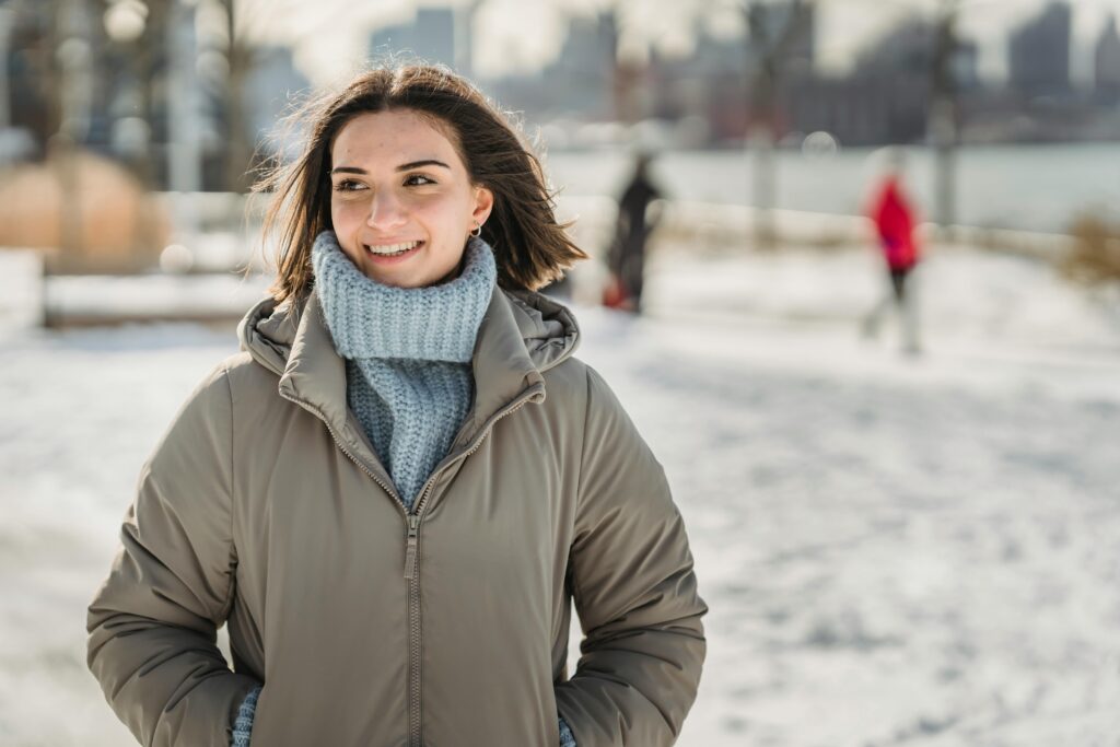 a woman outside in the snow on a sunny day