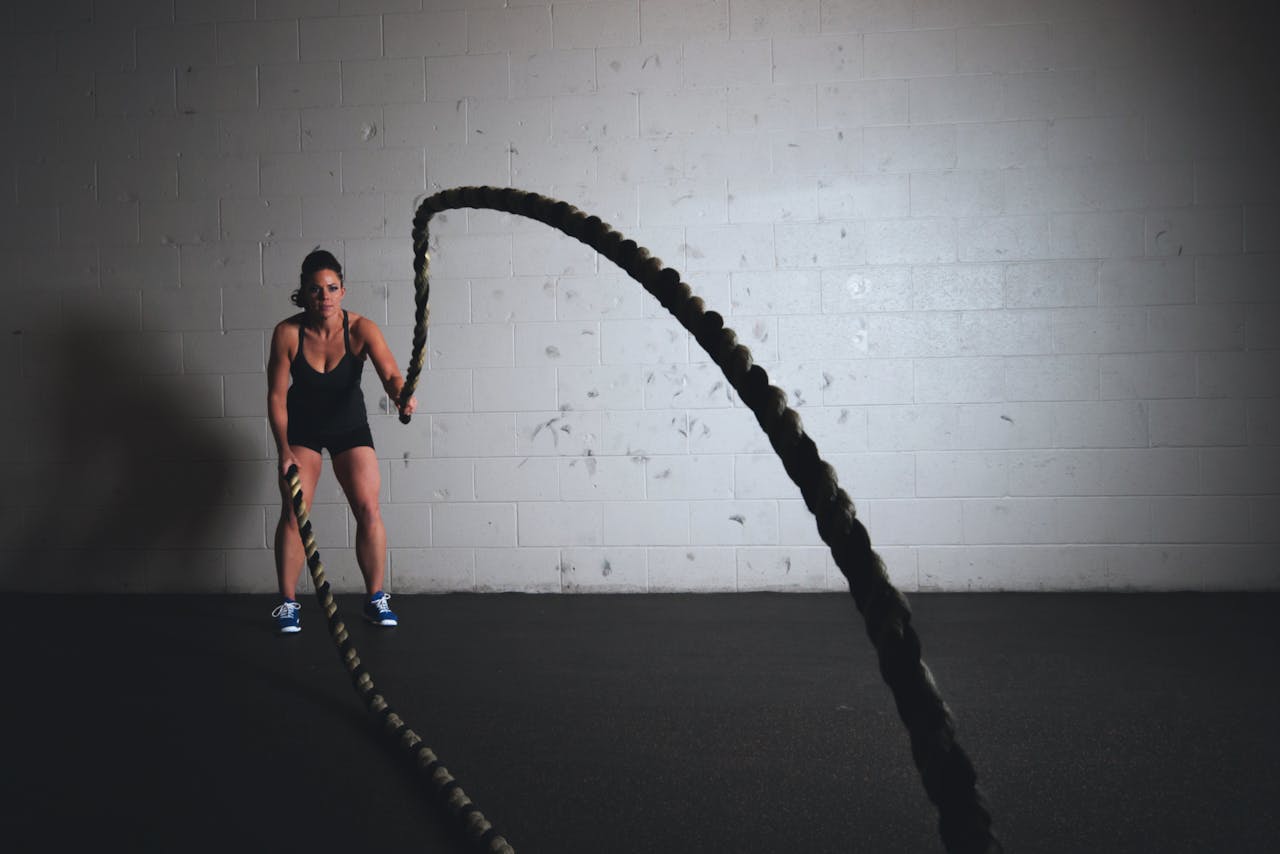 A woman holding exercise ropes, a way of crushing your exercise goals