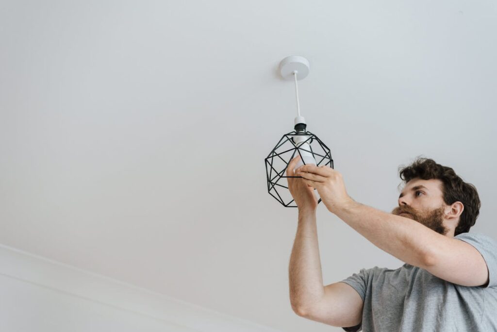 A man changing a light-bulb