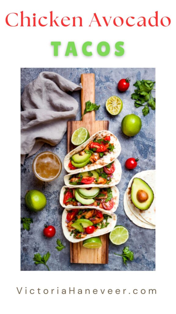 Chicken tacos with avocado and cherry tomatoes on a wooden board