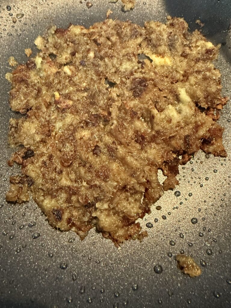 Rempah for kari kapital turning brown in a pot.