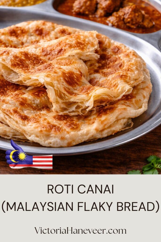 Freshly cooked roti canai flaky flatbread on griddle.