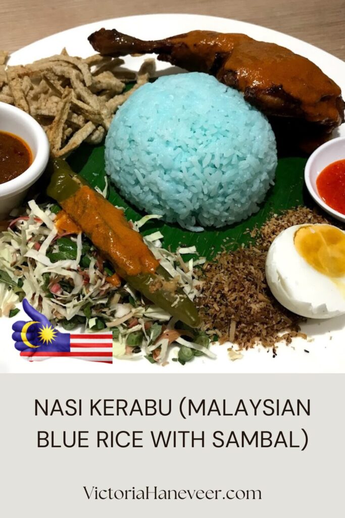 Nasi kerabu dish from Malaysia with blue rice, sambal, boiled egg and condiments.