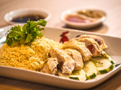 A platter of Hainanese chicken and rice, a Malaysian-Chinese dish.