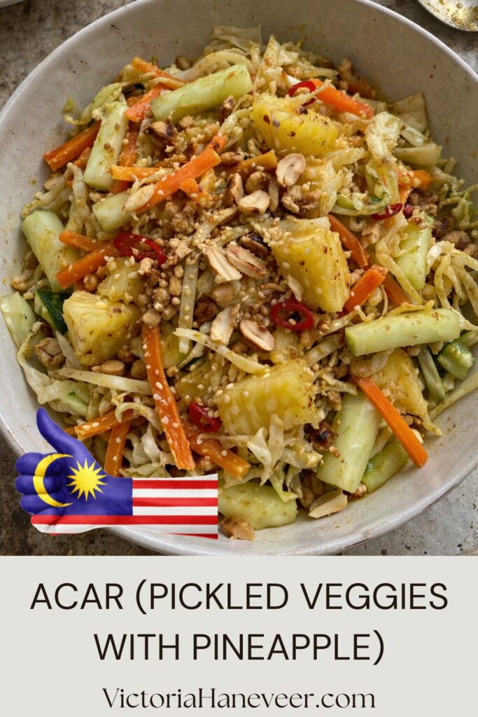 Bowl of acar pickled vegetables with peanuts and sesame seeds.
