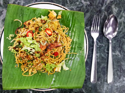 A portion of mee goreng served on a banana leaf.