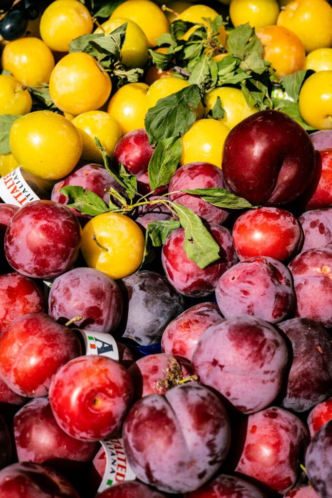 Fresh plums at a market for sale.