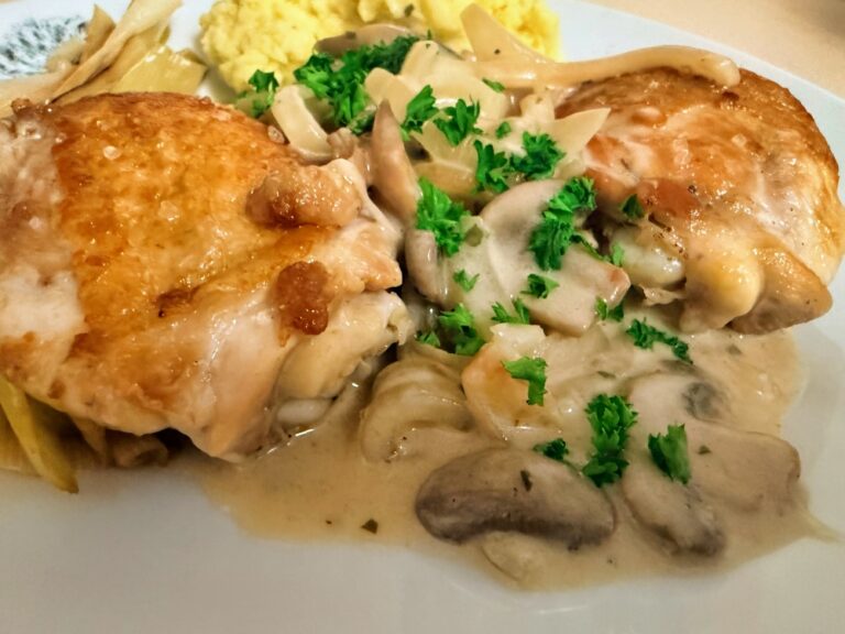 Crispy chicken thighs with creamy mushroom sauce, parsley, braised leeks and mashed potatoes.